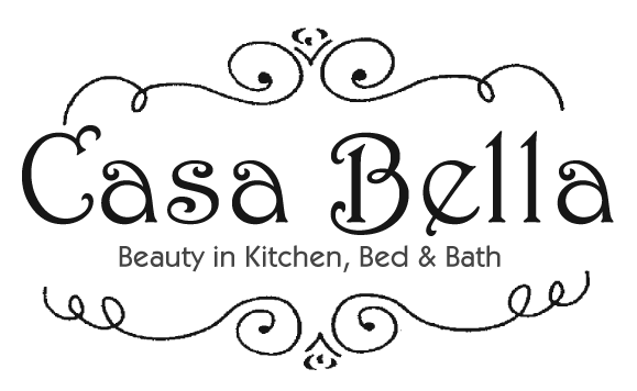 The sign for Casa Bella in Crested Butte, CO. The sign is rounded on the top and sticks out on the sides on top of a rectangular shape. The sign reads "Beauty in Kitchen, Bed & Bath Casa Bella"