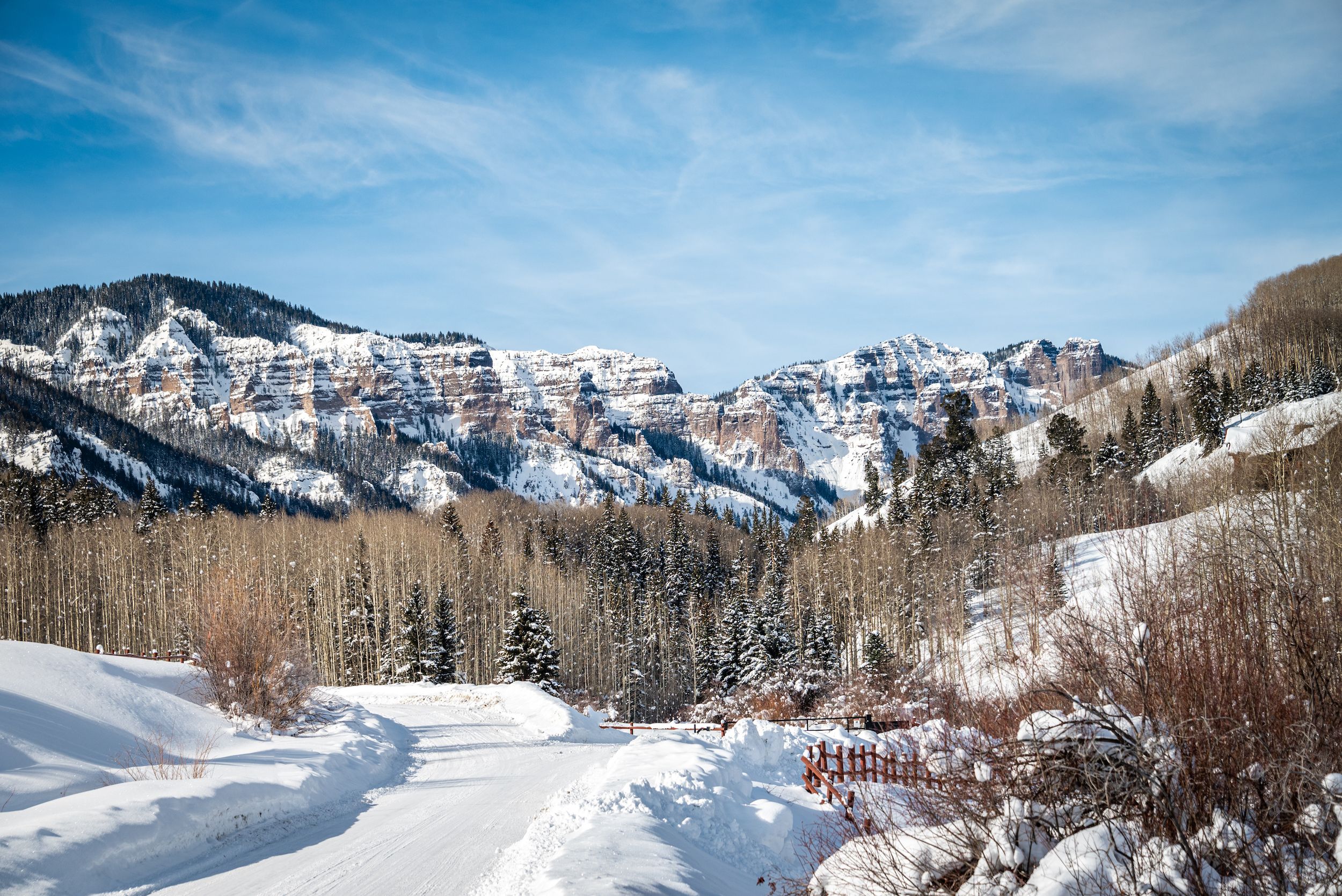 mountain peaks dusted with snow. A path heads towards the peaks