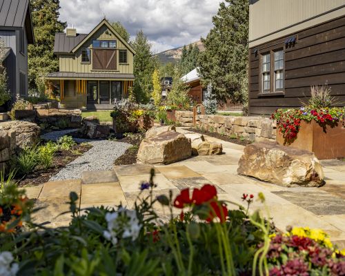 A courtyard with plants and a gravel path at the Academy Place Crested Butte, Colorado