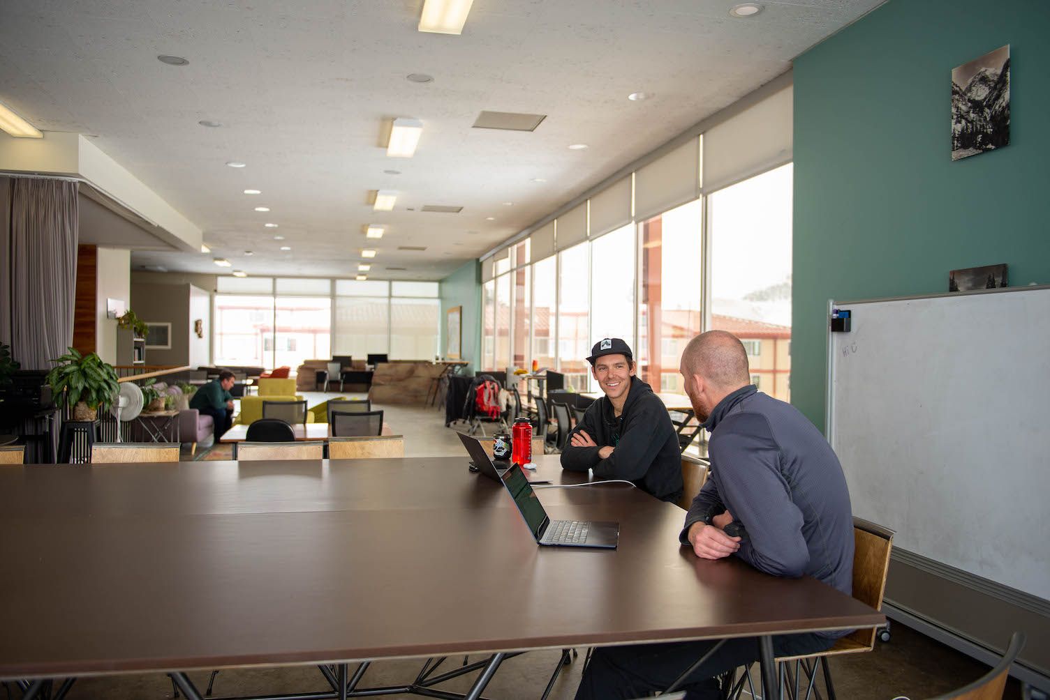 two people sitting at a desk for a meeting at the ICELab at western in gunnison