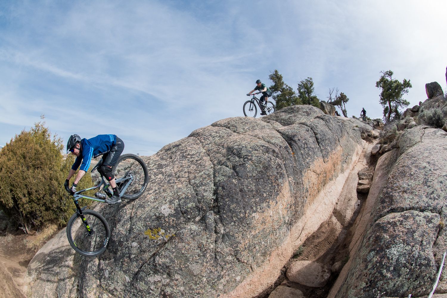 Mountain bikers riding down a rock slope