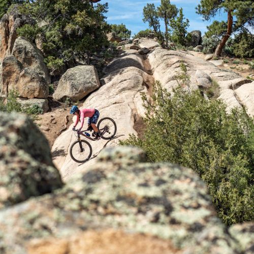A person riding a bike down a rocky slope at Hartman Rocks