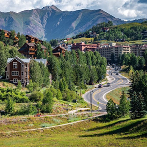 Mountains in the distance with buildings and a road in the foreground