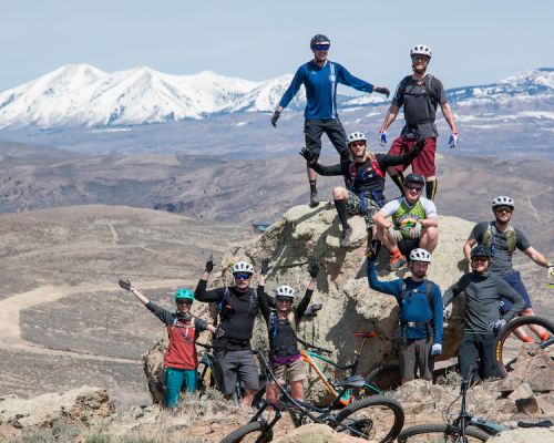 a group of bikers on a peak