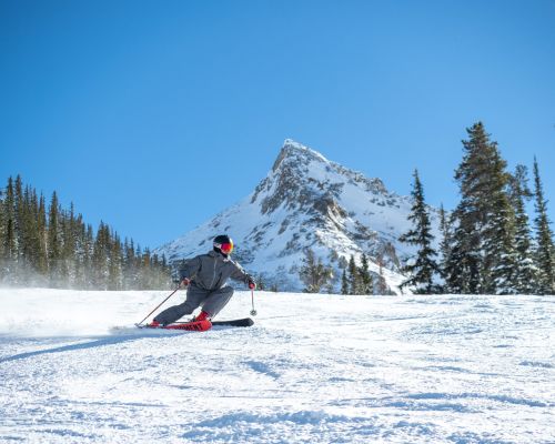 A skier carves across International, the steepest groomed ski run in North America.
