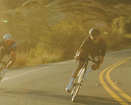 two people riding road bikes with brevay cycling shoes