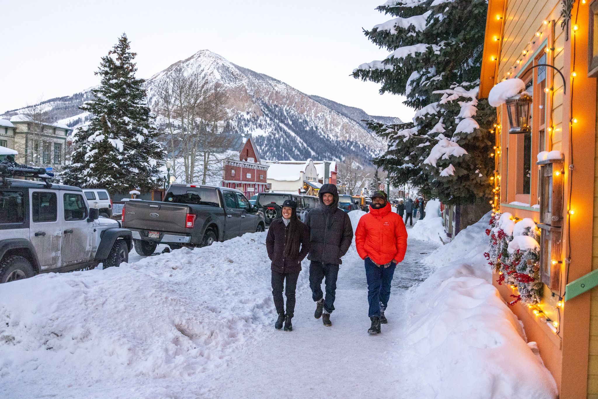 Three people walk down downtown Crested Butte in the snow