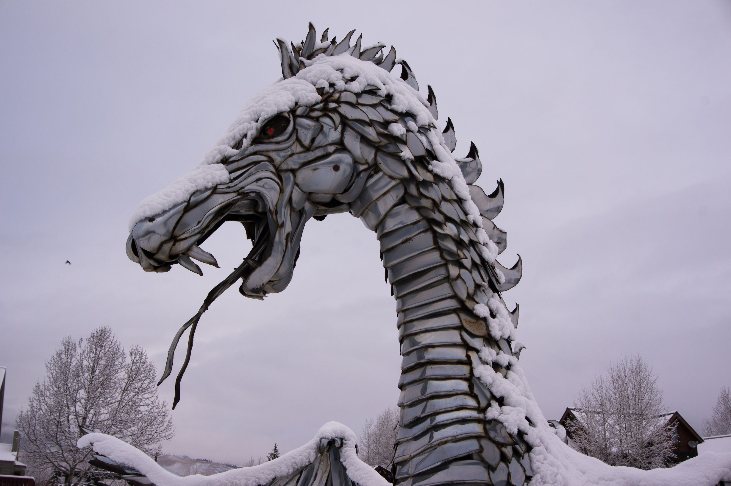 a metal dragon covered in snow in crested butte