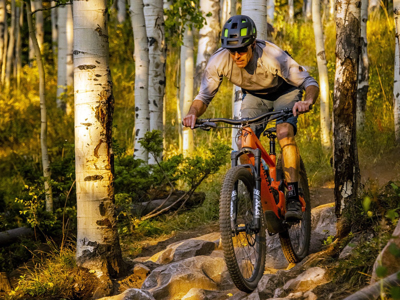 E-biking on a trail bike through the aspen trees in Crested Butte in fall.