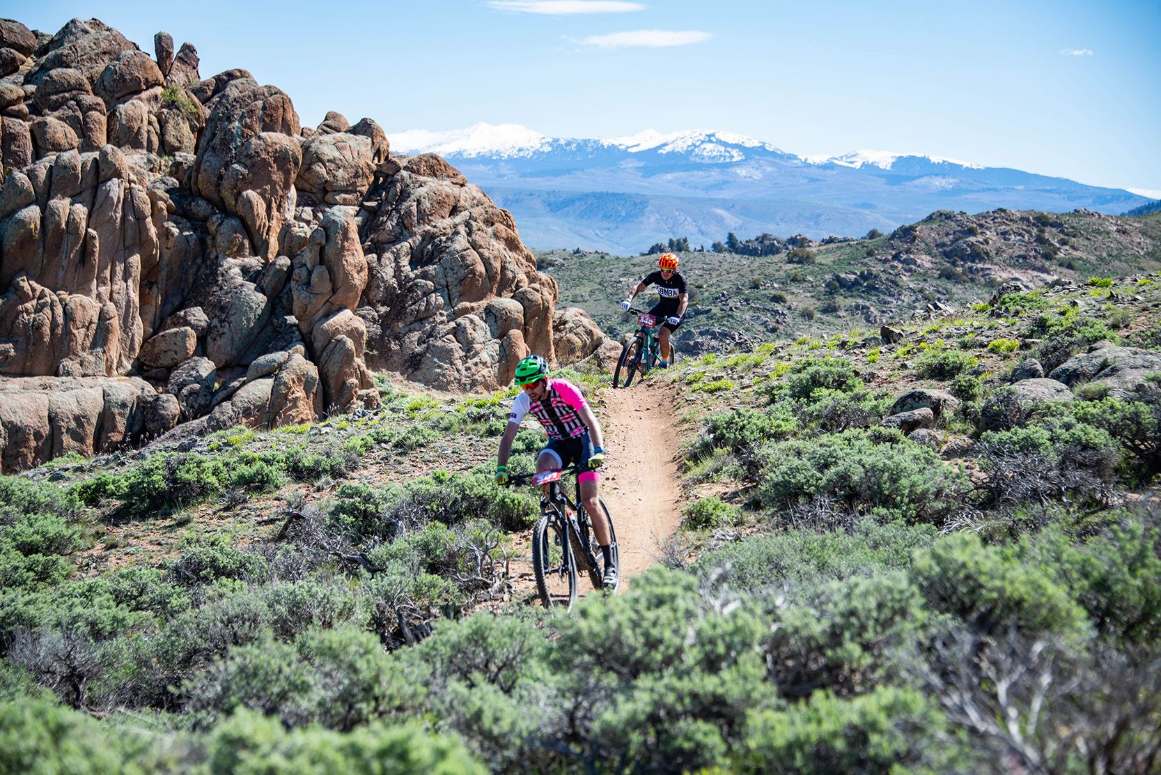 Two people ride mountain bikes at Hartman Rocks in spring.