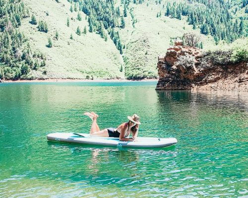 a woman on a paddle board SUPing in Gunnison, CO