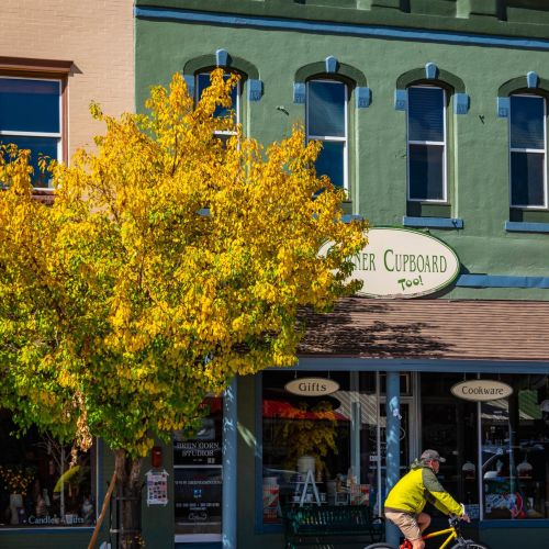 a person rides a bike on downtown street