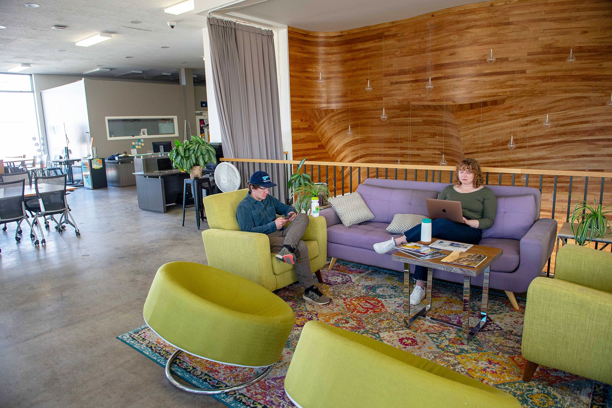 Two people work while sitting on the ICELab couches.