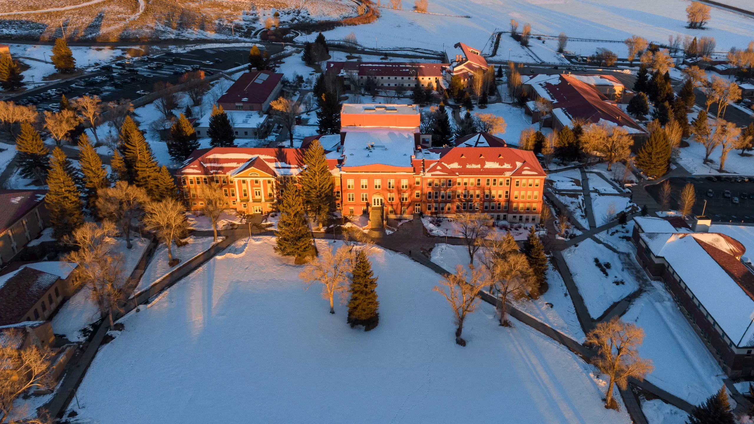 The sun sets on Taylor Hall at Western Colorado University in winter.