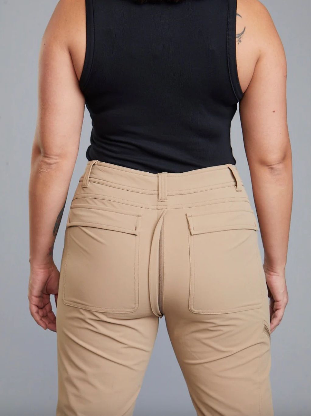 The back of a woman's pants shows a hidden second zipper.