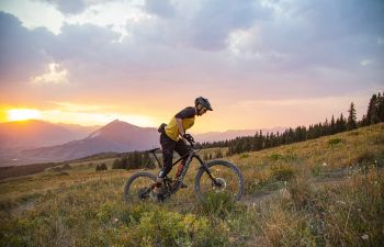 A mountain biker rides a trail in fall at sunset near Cement Creek road outside Crested Butte.