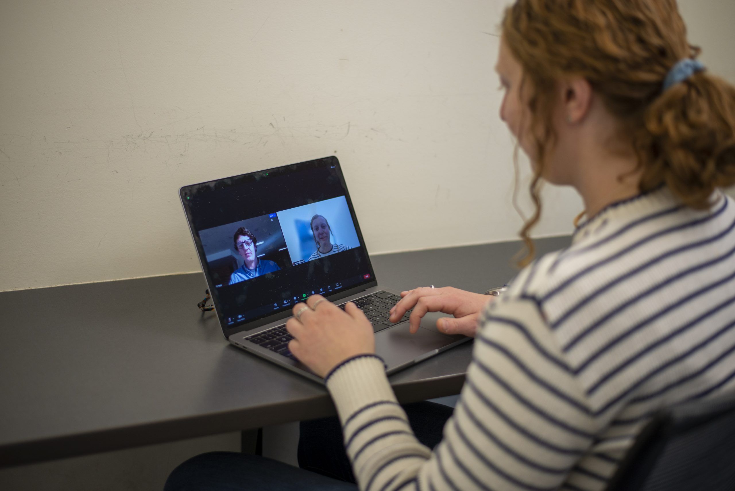 A woman sitting at a laptop at a Gunnison coworking space