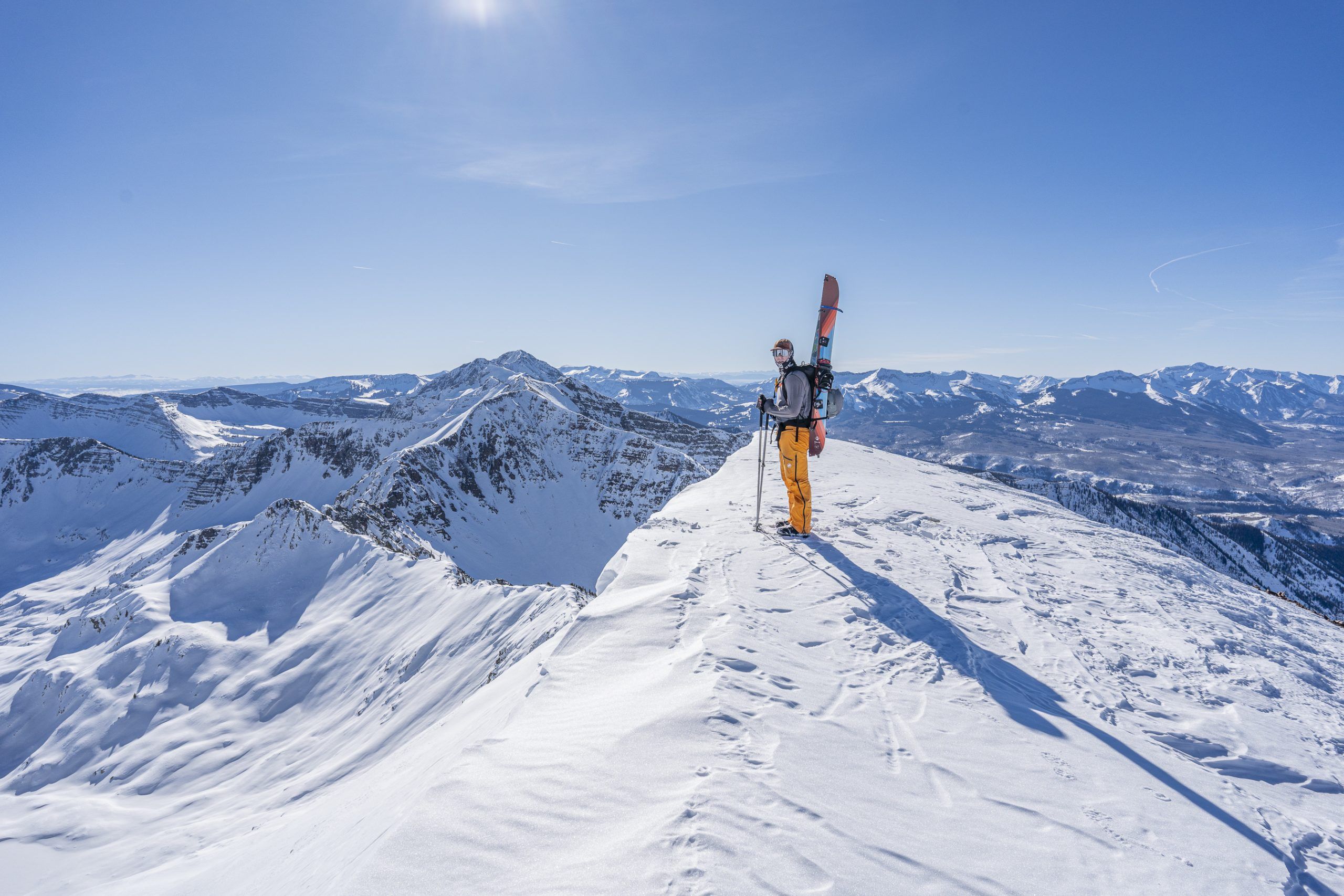 A man goes backcountry skiing in Crested Butte on a bright winter day