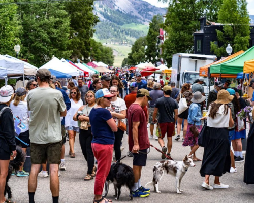 A busy street with tents for the crested-butte-farmers-market