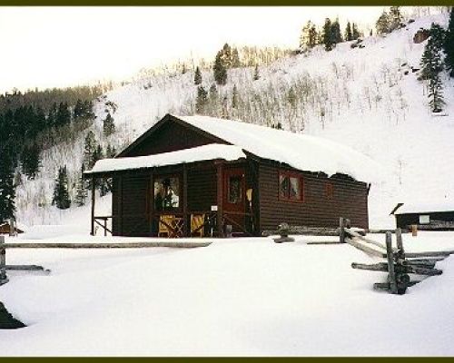 A Cement Creek Ranch cabin in the snow.