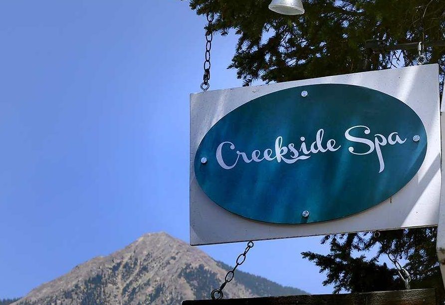 Two massage tables set up for a couples massage at creekside spa in crested butte, co. The room the tables are in has soft light and a window.