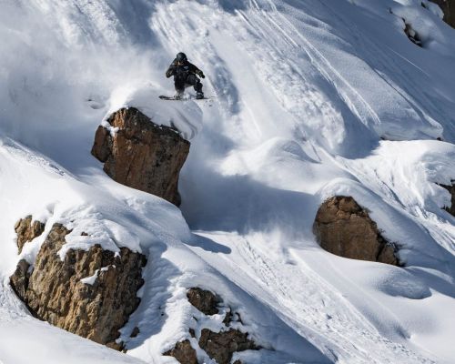 A snowboarder hucks a rock during the Natural Selection Tour DUEL at Crested Butte in 2024.