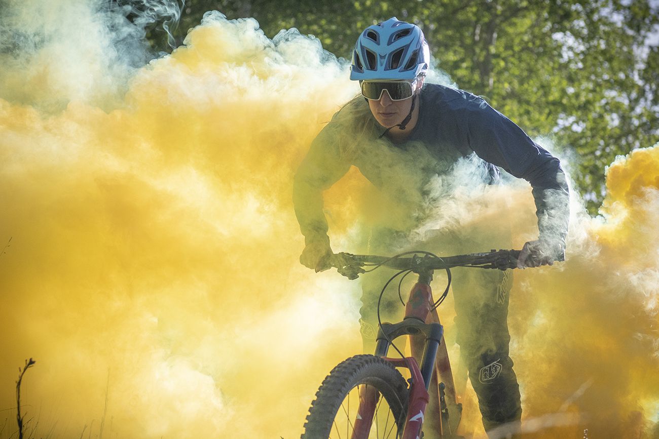 Micayla Gatto rides her mountain bike through yellow smoke in "Micayla in Wonderland."
