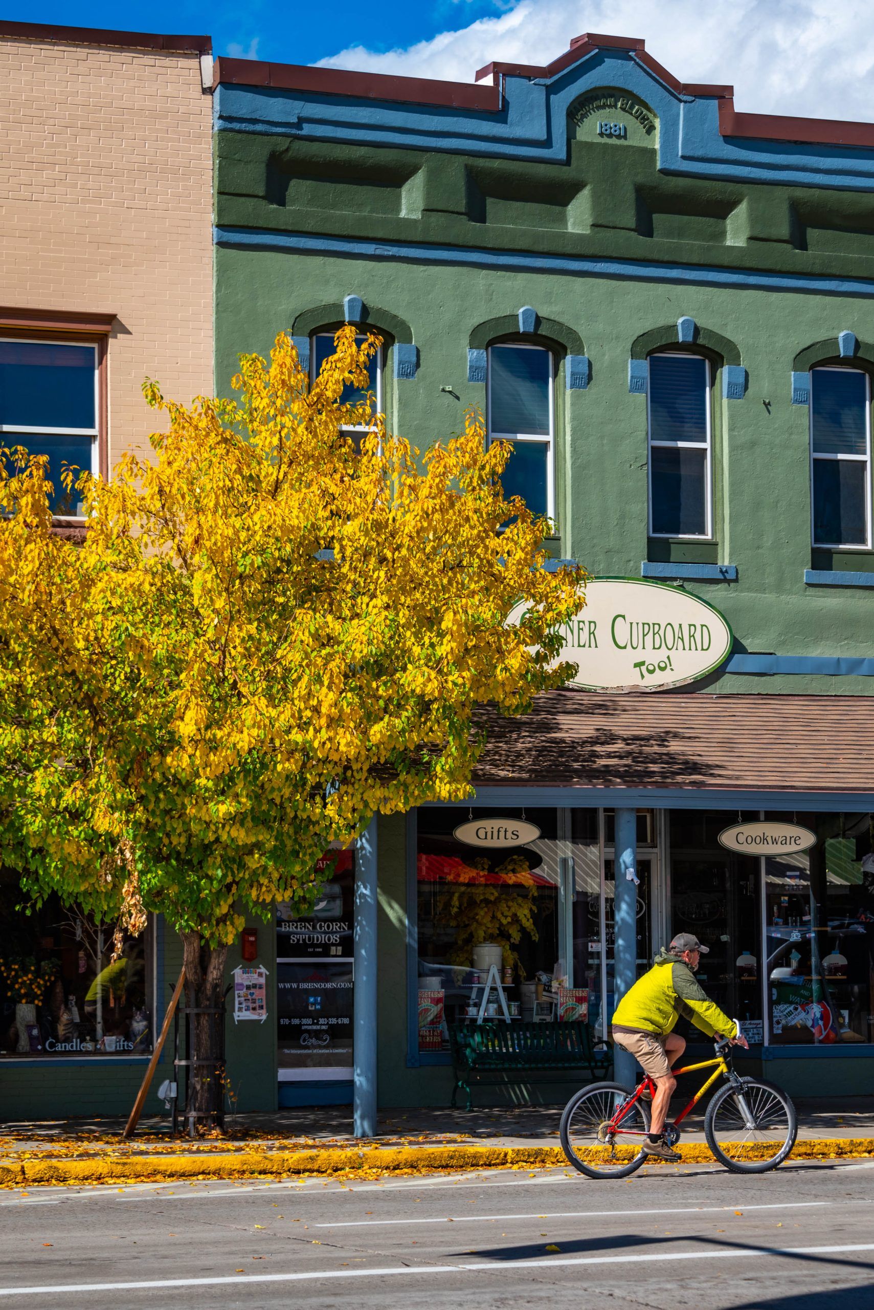 a person rides a bike on downtown street