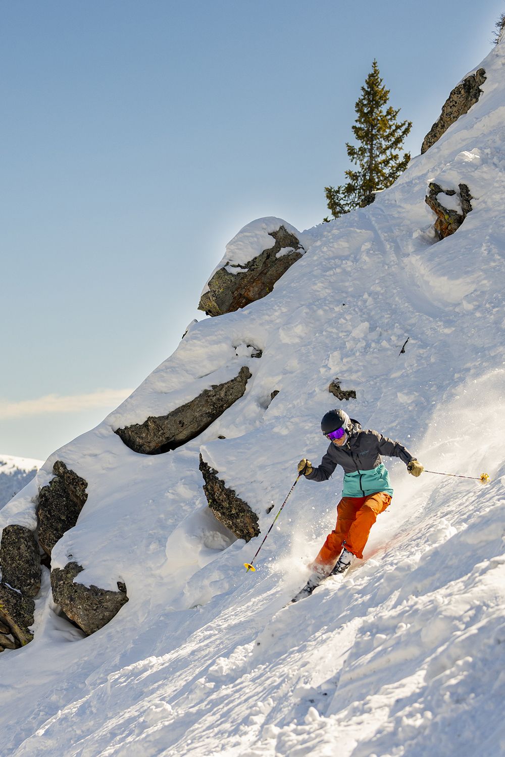 A woman skiing extreme terrain on a sunny winter day in Crested Butte, Colorado.