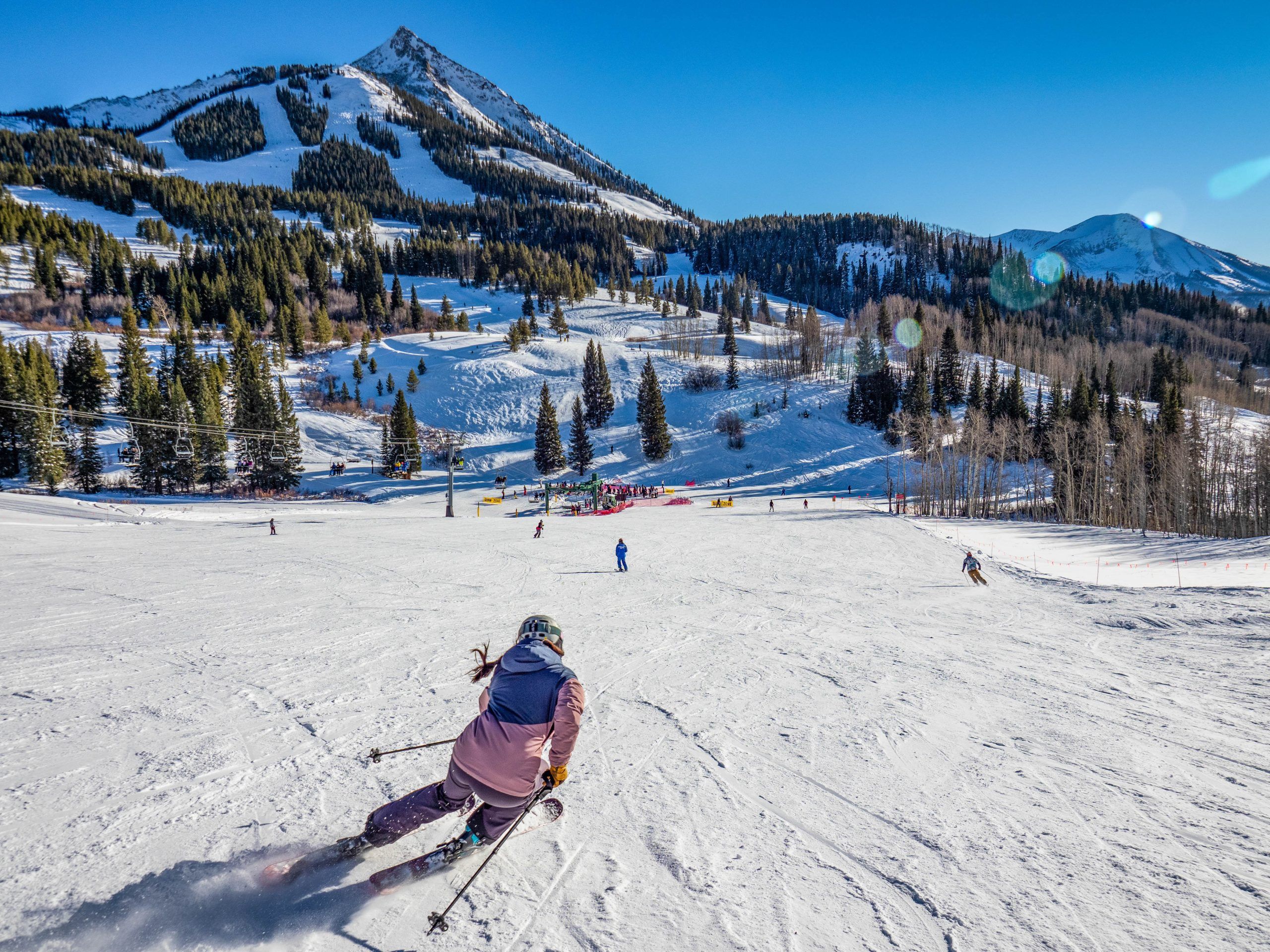 A person skis down a gentle slope. Painter Boy lift serves mostly easy terrain at Crested Butte Mountain Resort.