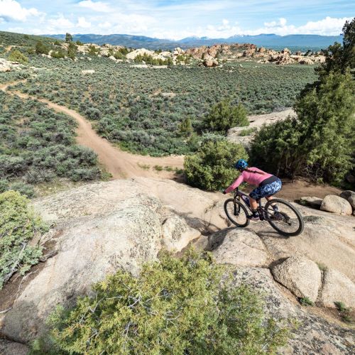 a woman mountain biking at hartman rocks 