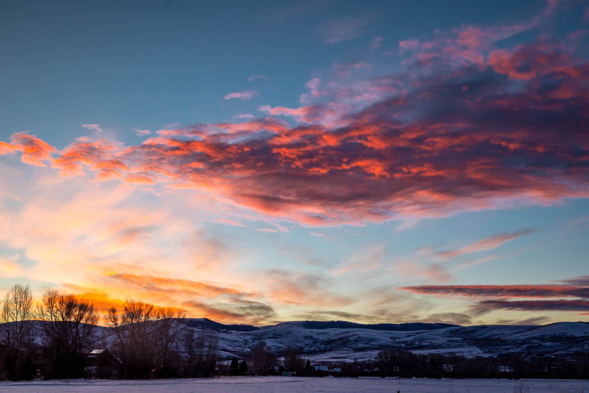 A sunset over a snowy landscape