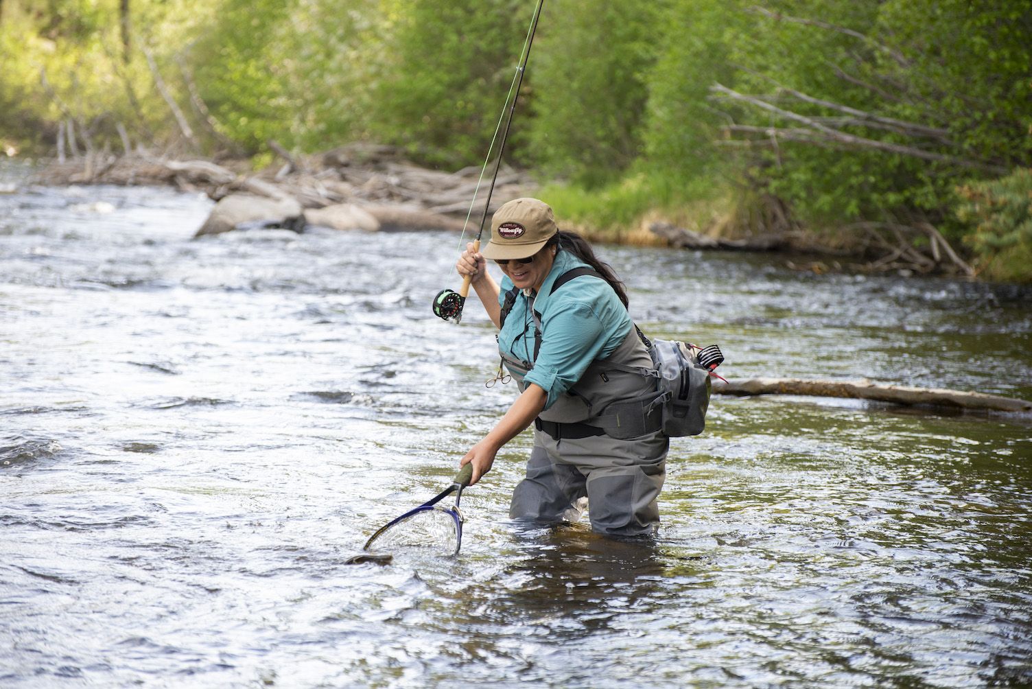 A woman fly fishing on the taylor river