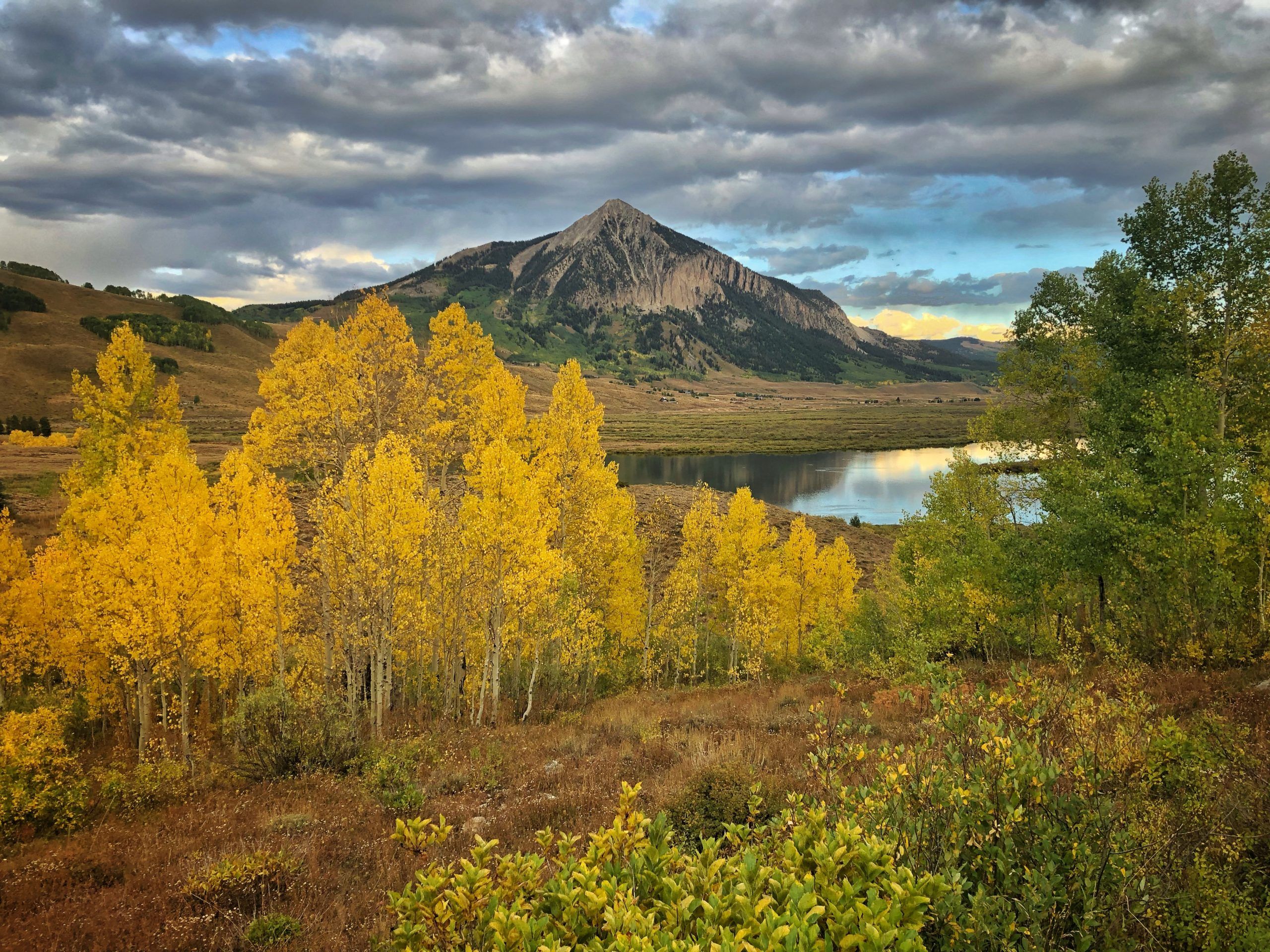 Crested Butte Mountain in Crested Butte, Colorado on a cloudy fall day with yellow aspen leaves.