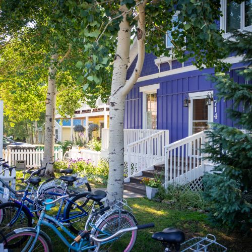 A house with a picket fence and bicycles. One of the many Crested Butte lodging properties 