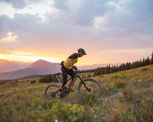 A mountain biker rides a trail in fall at sunset near Cement Creek road outside Crested Butte.