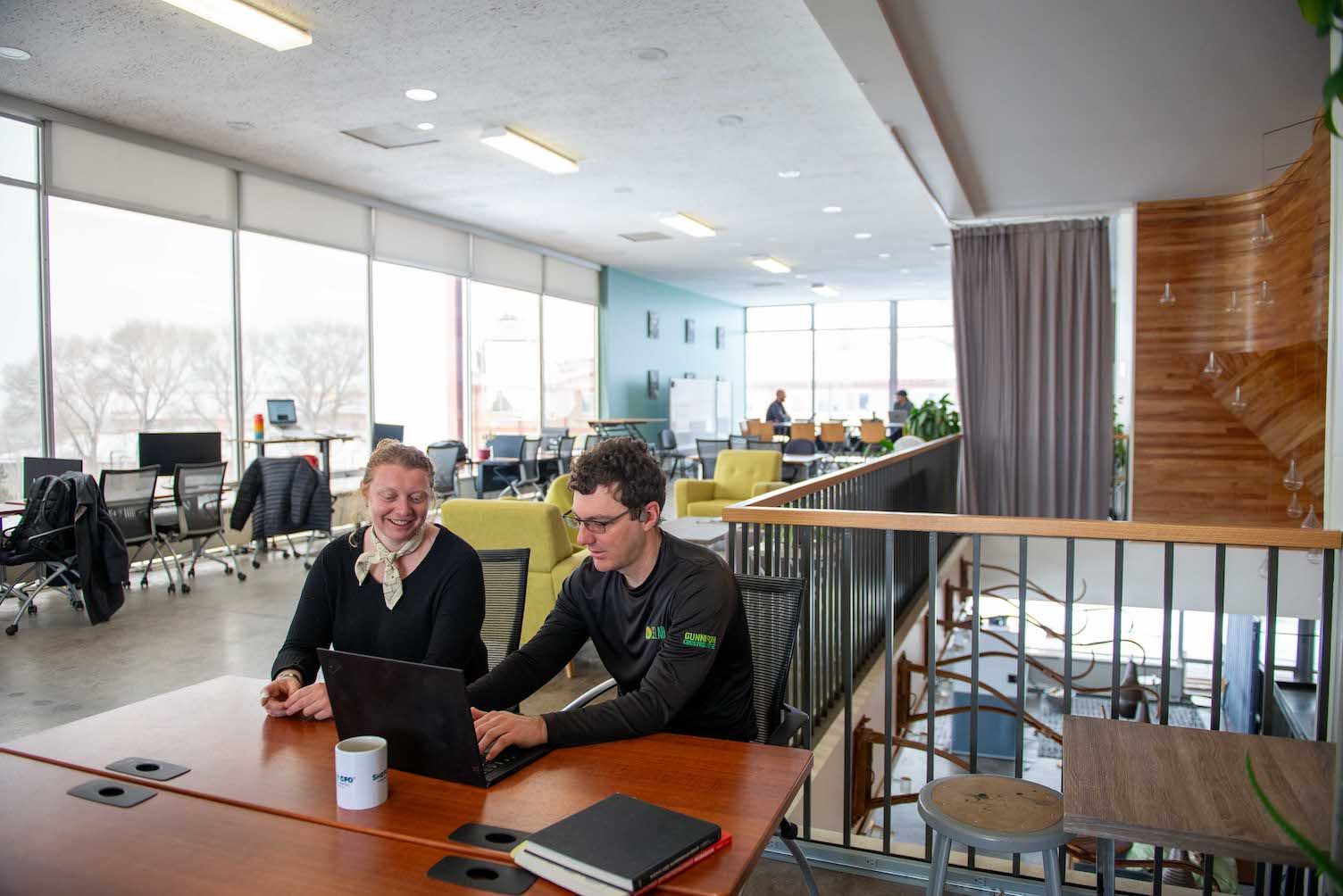 two people sitting at a desk in the icelab coworking space in Gunnison