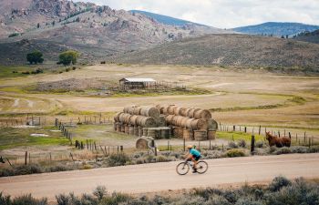 Gravel biking past a hay farm in Gunnison, Colorado in summer