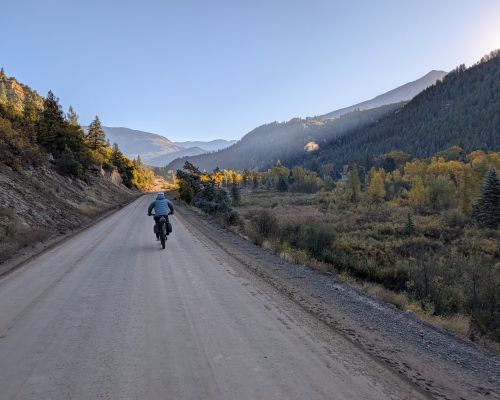 Bikepacking Gunnison County in fall on a smooth gravel road.