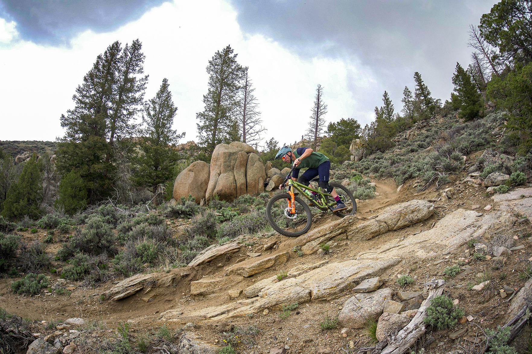 Brice Shirbach rides MTB down a steep, rocky trail in Gunnison, Colorado during spring.