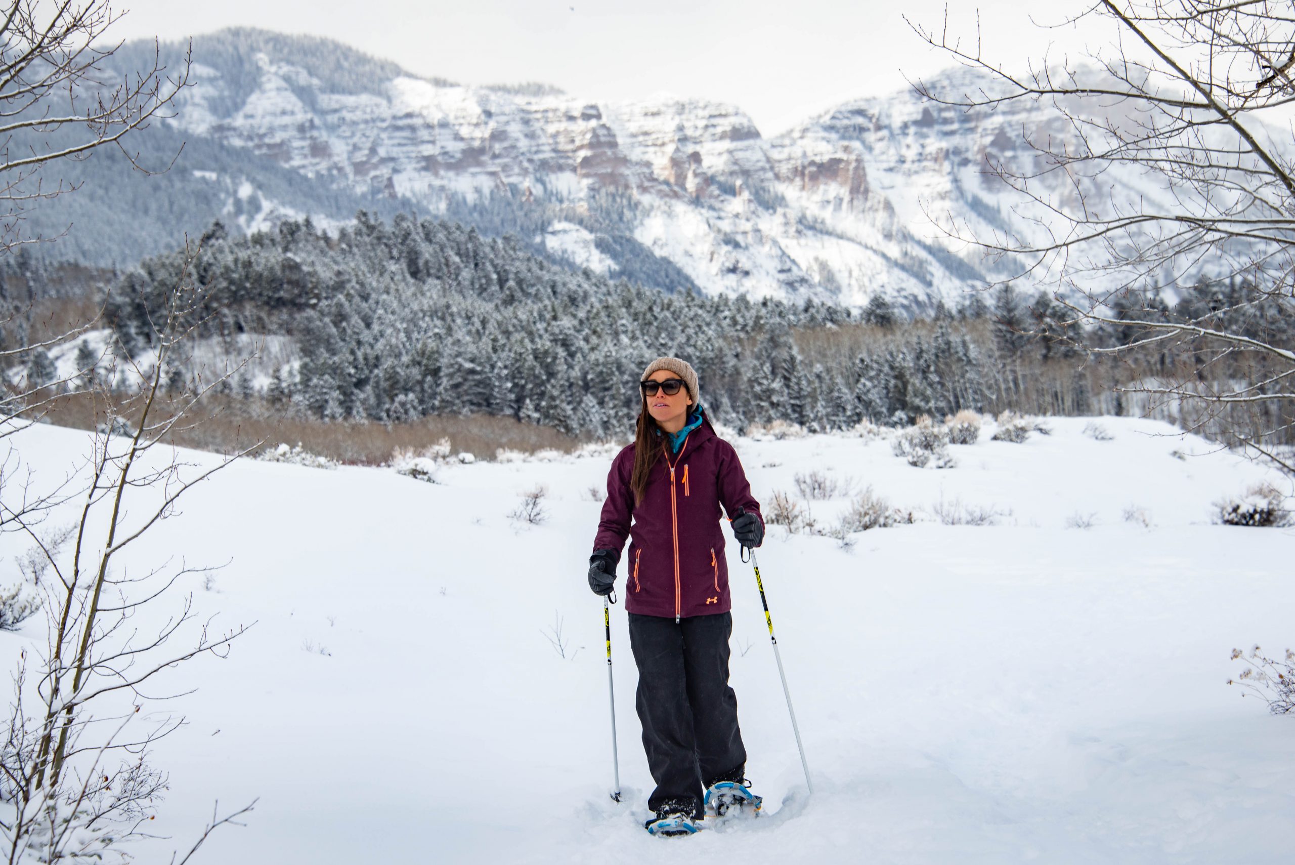 A woman snowshoes on a trail in Colorado.