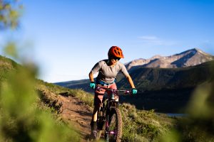 A woman mountain bikes on a trail in Crested Butte, Colorado.