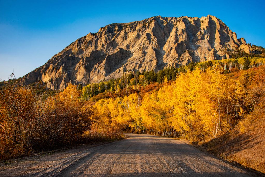 a peak with fall leaves and a road