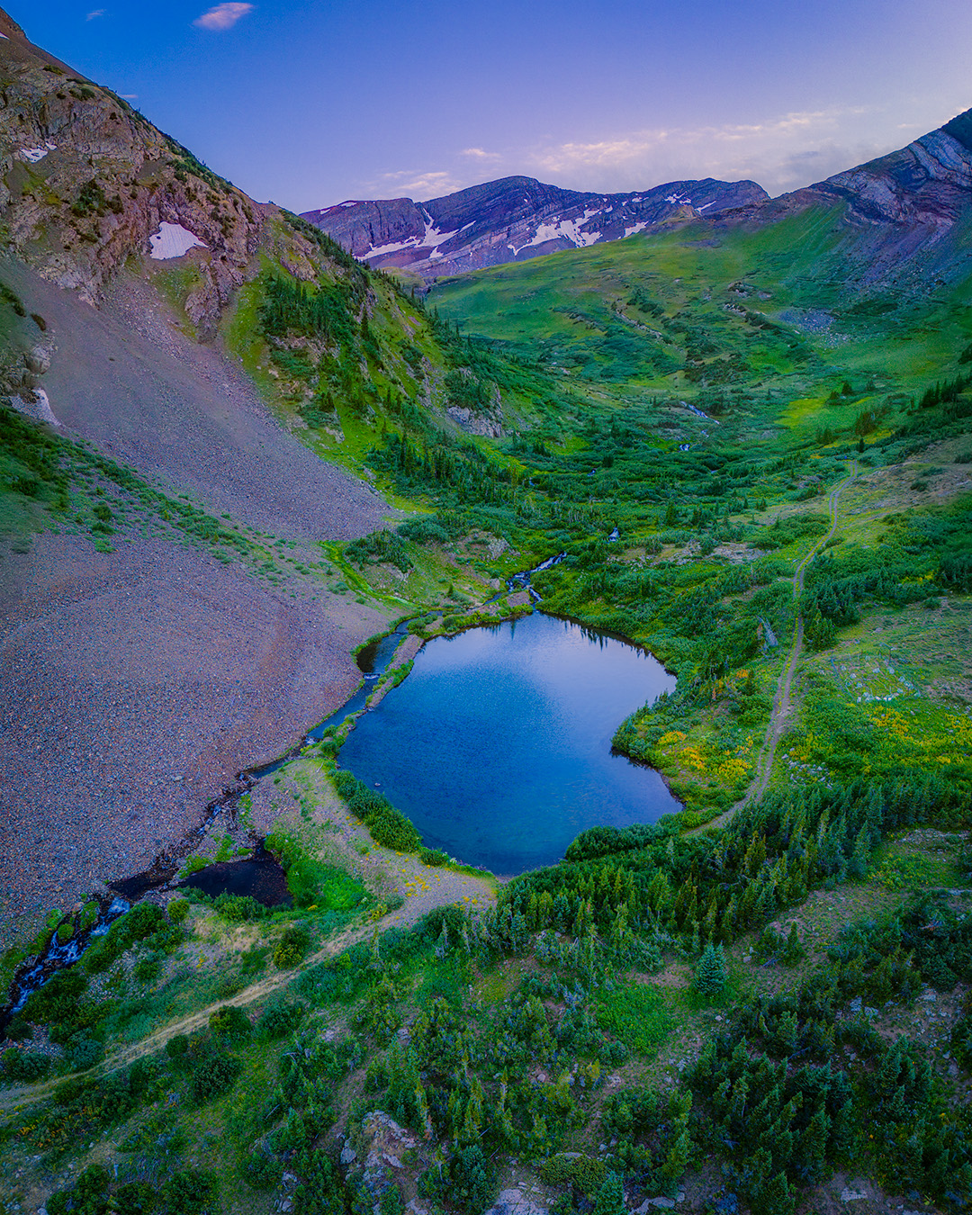 an aerial view of a mountain lake, north pole lake in maroon bells