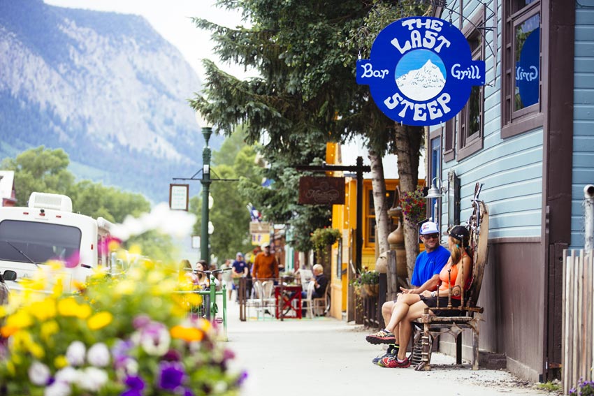 A couple sitting on a bench on Elk Avenue.