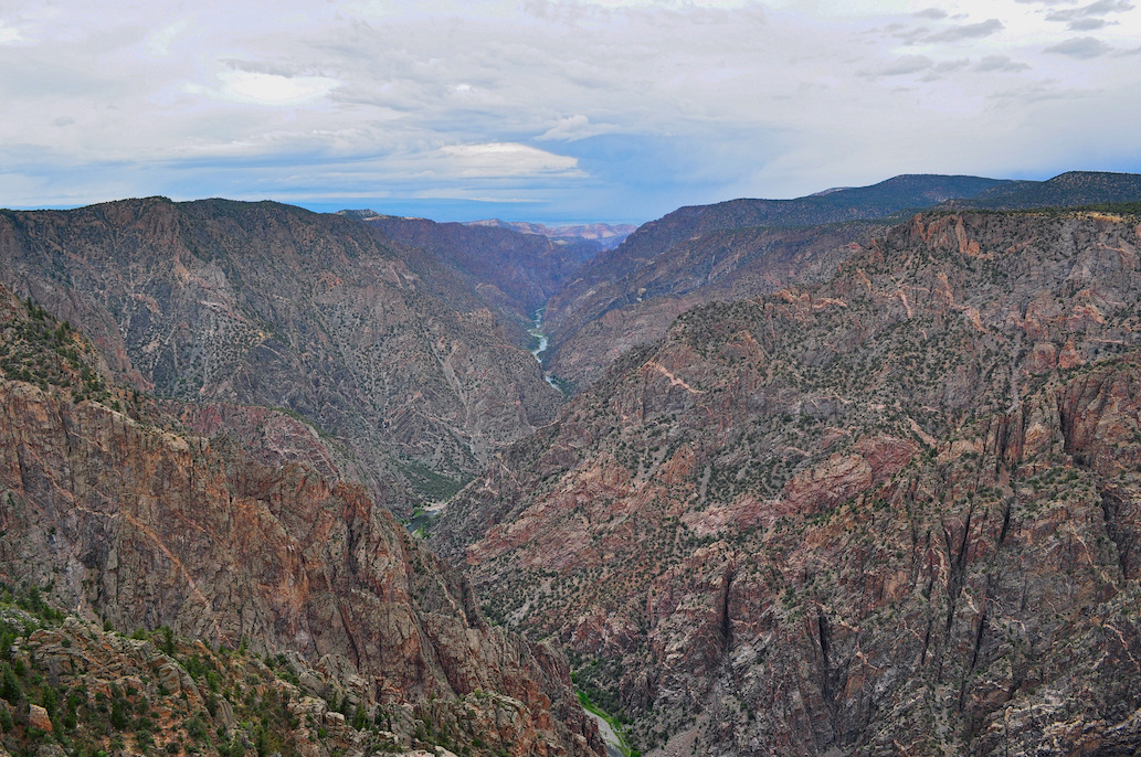 An aerial view of a canyon with a river running through it. This canyon is Black Canyon