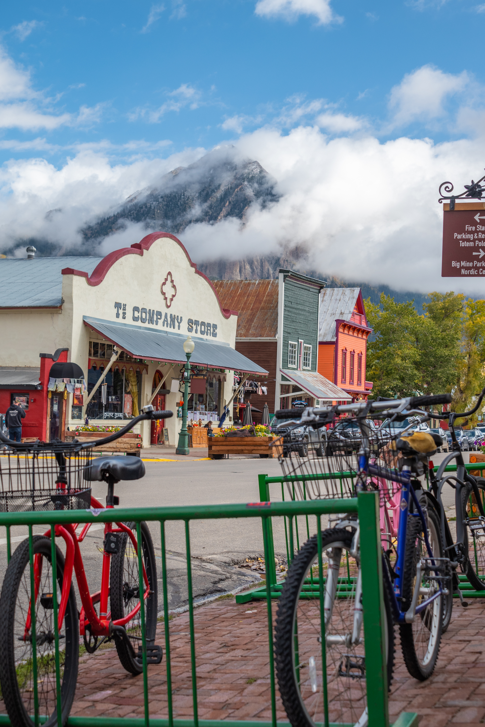 a downtown view of crested butte, co with a mountain peal shrouded by clouds in the background