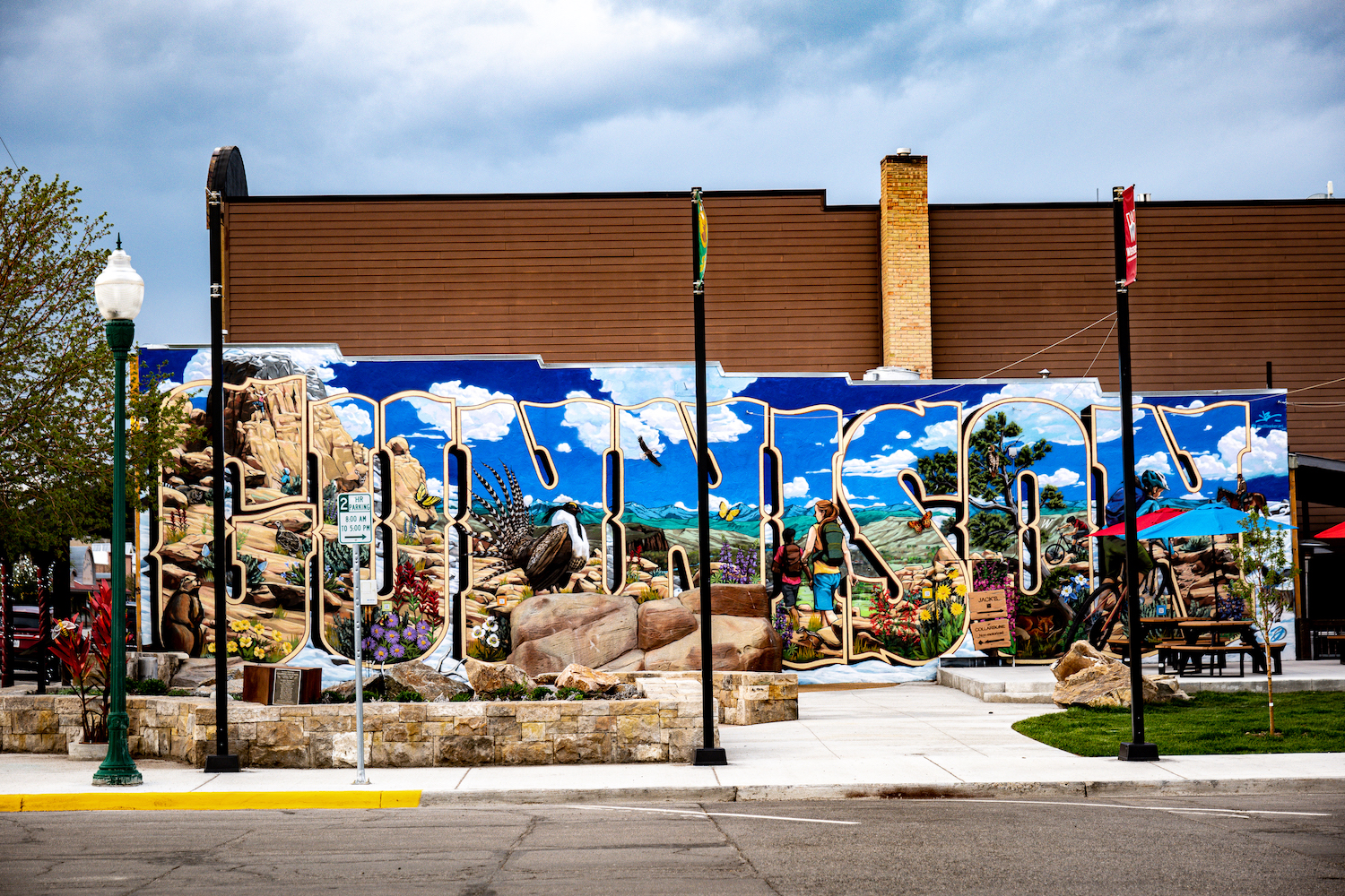 A mural on the side of a building that spells out the word "Gunnison"