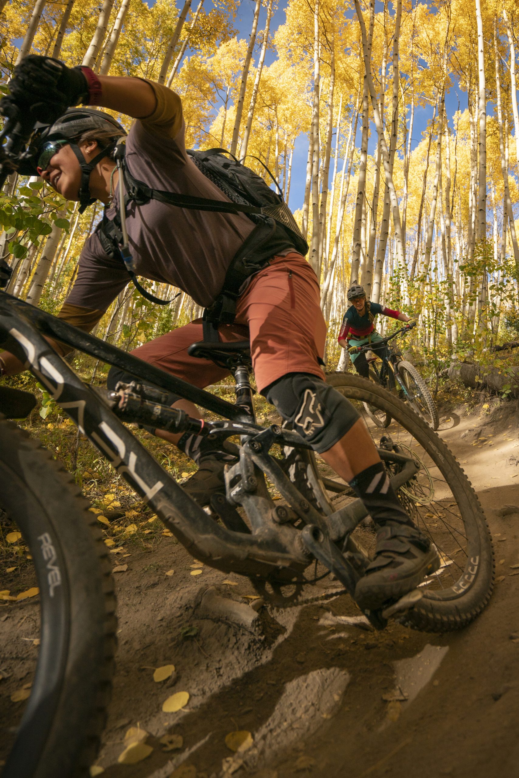 Two people ride mountain bikes on a Colorado fall weekend