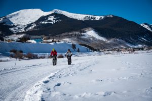 Two people fat biking in Crested Butte with Red Lady in the background.